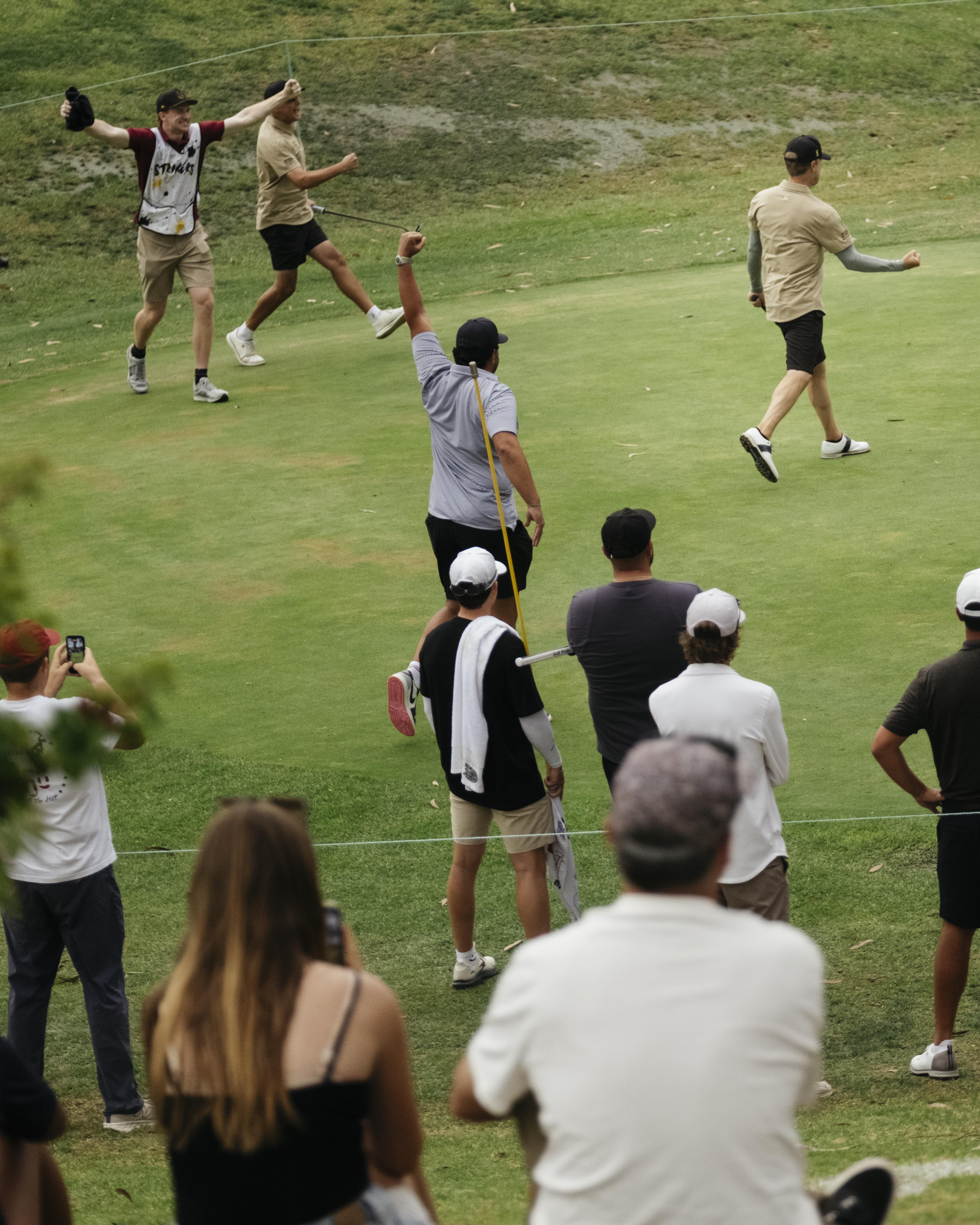 Scottsdale Strikers celebrate on the green as fans watch from behind the ropes